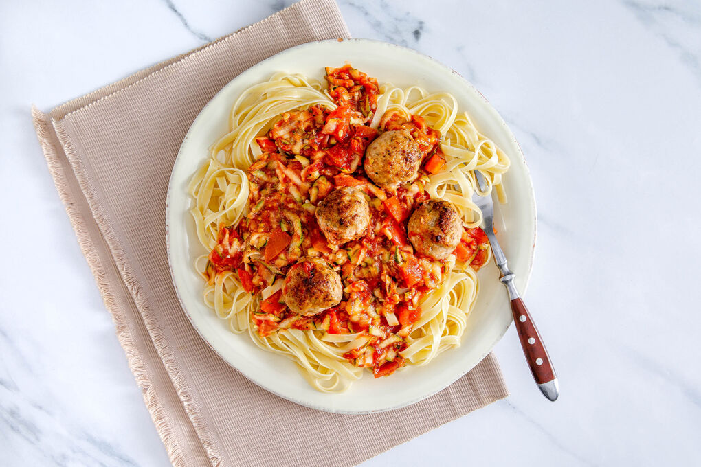 Italienische Hackbällchen auf Vollkornpasta mit fruchtiger Zucchini-Tomaten-Sauce