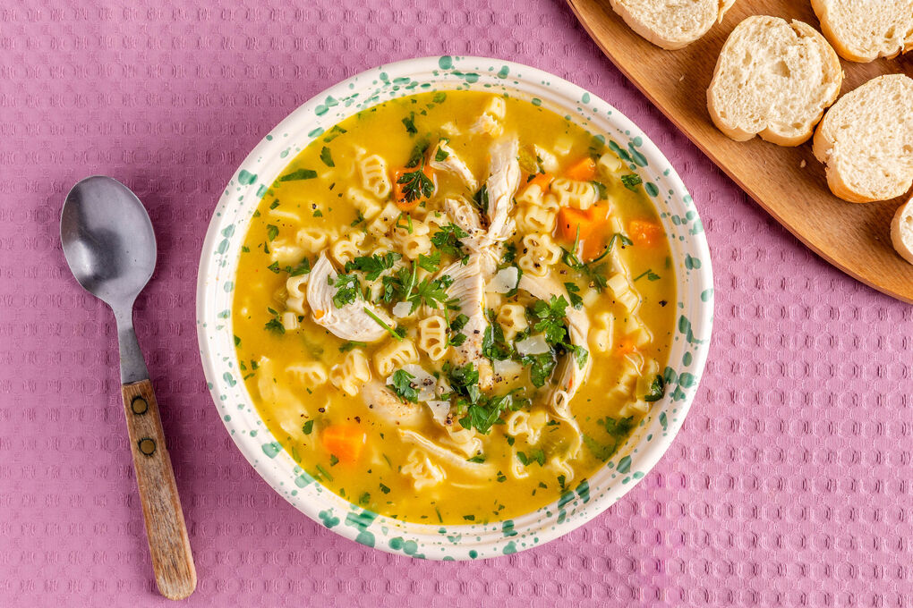 Bio-Hühnersuppe mit „Bauernhof“-Pasta mit Gemüse und Käse, dazu Baguettescheiben