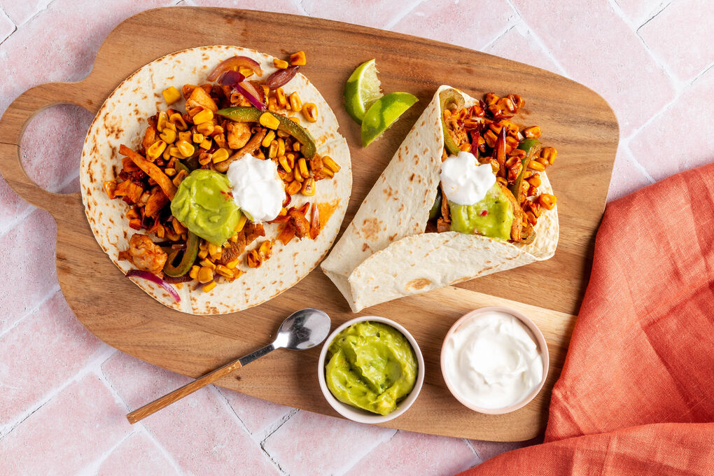 Schnelle Hähnchen-Fajitas mit Mais & Paprika garniert mit Guacamole und saurer Sahne