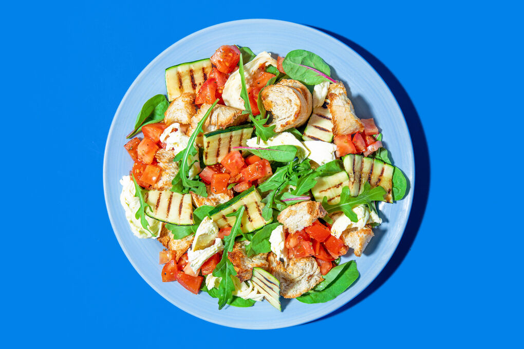 Salat mit Tomate, Mozzarella und Zucchini garniert mit knusprigen Croûtons