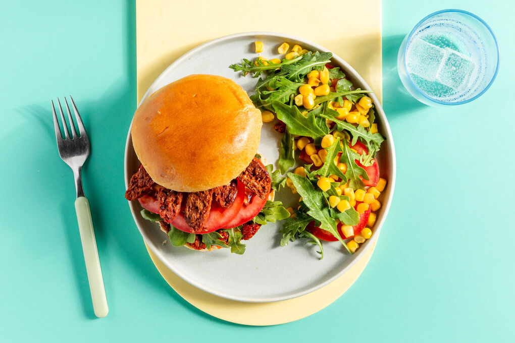 Vegetarischer Chorizoburger mit Rucola, Mais und Tomaten